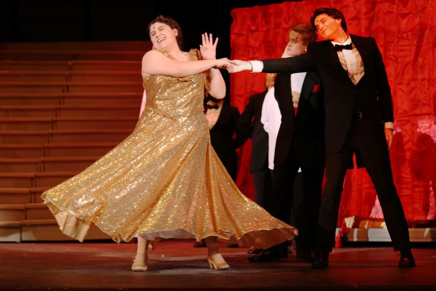 Senior Sydney Fendler (Dolly Levi) dances with senior Justin Miller (Ensemble) to greet Dolly’s arrival to the Harmonia Gardens. The spring musical, Hello Dolly, took place March 10-12. 