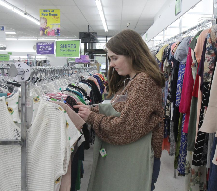 As+she+pines+through+her+selection%2C+senior+Anna+Kelley+looks+to+find+shirts+at+Goodwill%2C+one+of+the+local+thrift+stores