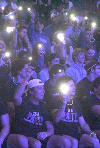 On April 14, seniors hold their phone flashlights to cheer
sophomore Ava Rhine playing the guitar. The Renaissance
academic pep assembly returned in person in the field house since 2019. (Photo by Tori Turner)