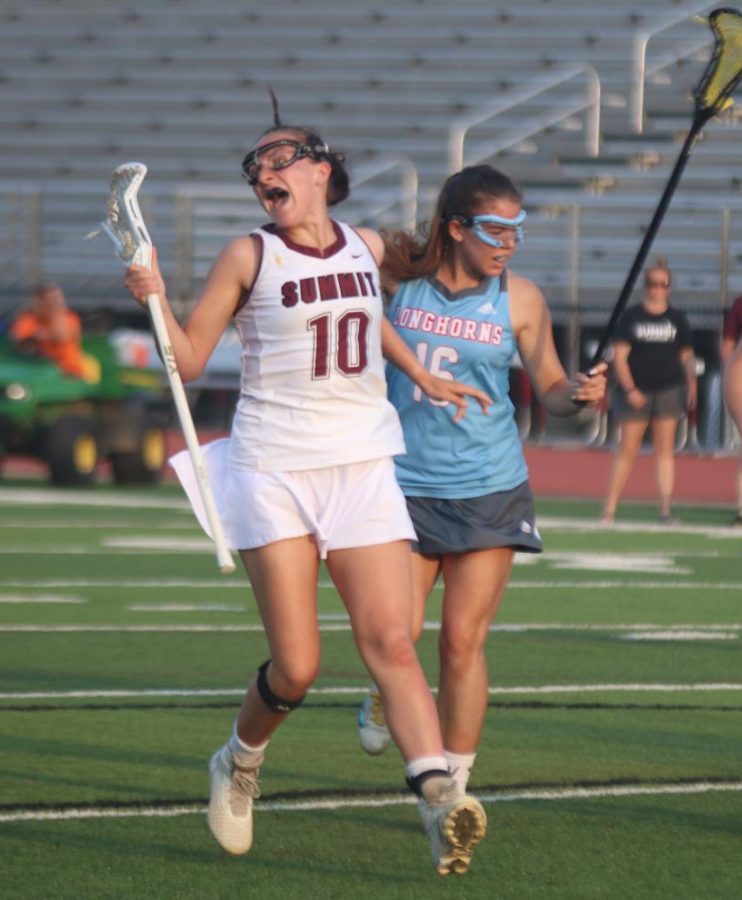 After scoring, senior Devon Crews (10) celebrates past Parkway Wests Maddie Humme. Crews scored four goals, helping the Falcons defeat the Longhorns 14-7.