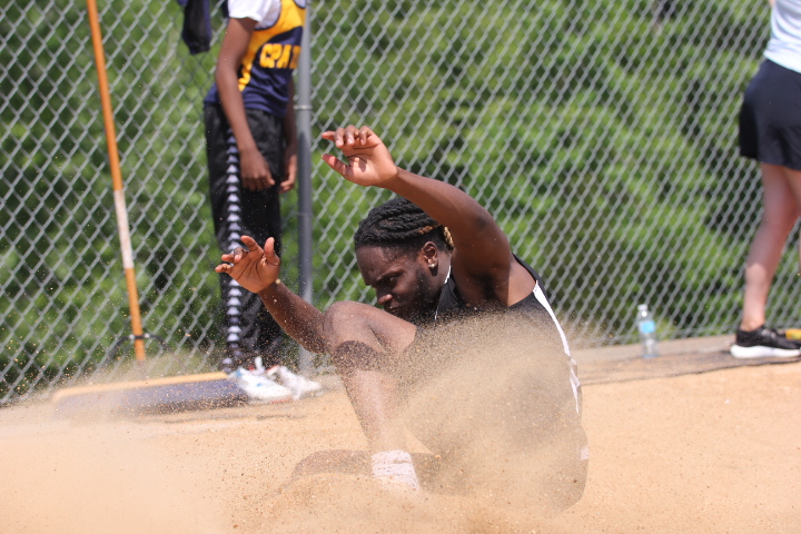 Senior+Samad+Mounger+lands+in+the+sand+after+performing+the+long+jump.+Mounger+placed+6th%2C+jumping+6.00m.%0ABoth+the+boys+and+girls+teams+placed+1st+at+the+District+championship+on+May+14.