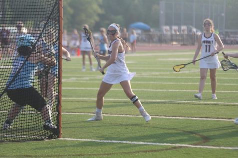 As she fakes a shot, senior Hannah McCutcheon moves the goalie to score. McCutcheon went on to score two goals for the Falcons, helping the team defeat the Parkway West Longhorns 14-7 on May 11 in their last regular season game.