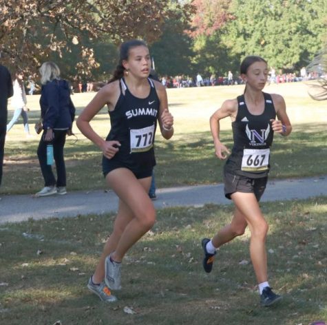Stiving ahead, junior Mia Brown runs by Kalina Zheleva of Parkway
North at the Suburban Conference Championship. Brown placed 8th in her conference  and 22nd overall at 20:11.