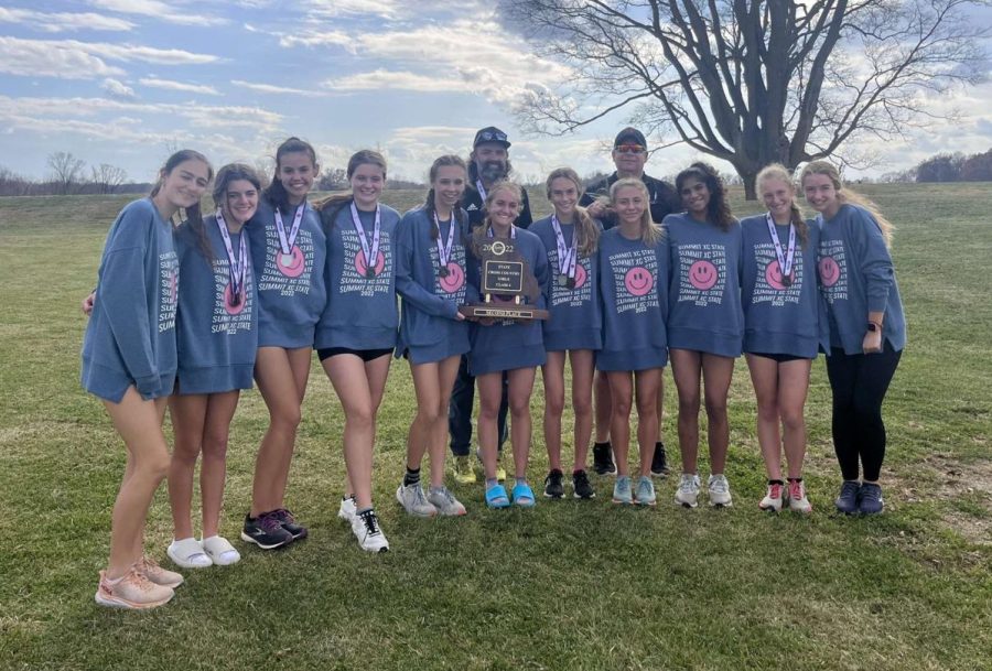 As they gather around their trophy, the girls cross country get a team photo after the event. The Falcons took 2nd place at the Class 4 State Championship on Nov. 4. (Photo used with permission by Paige Lehman)