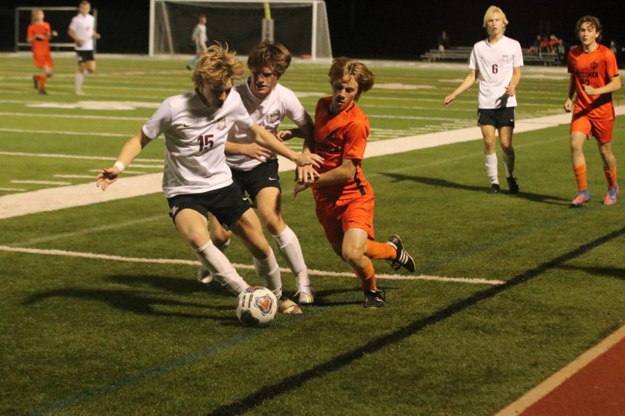 As senior Carter Williams keeps Gabe Wright of Webster Groves away from the ball, junior Austin Conger (15) dribbles down the field. The Falcons were defeated 1-0 by Webster Groves on. Nov. 3, ending their postseason.