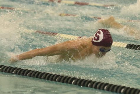As he swims the butterfly, junior Gabe Cusanelli comes up for air. Cusanelli placed 2nd in the 100 butterfly with a time of 56.75 at the State Consideration meet on Nov. 2.
