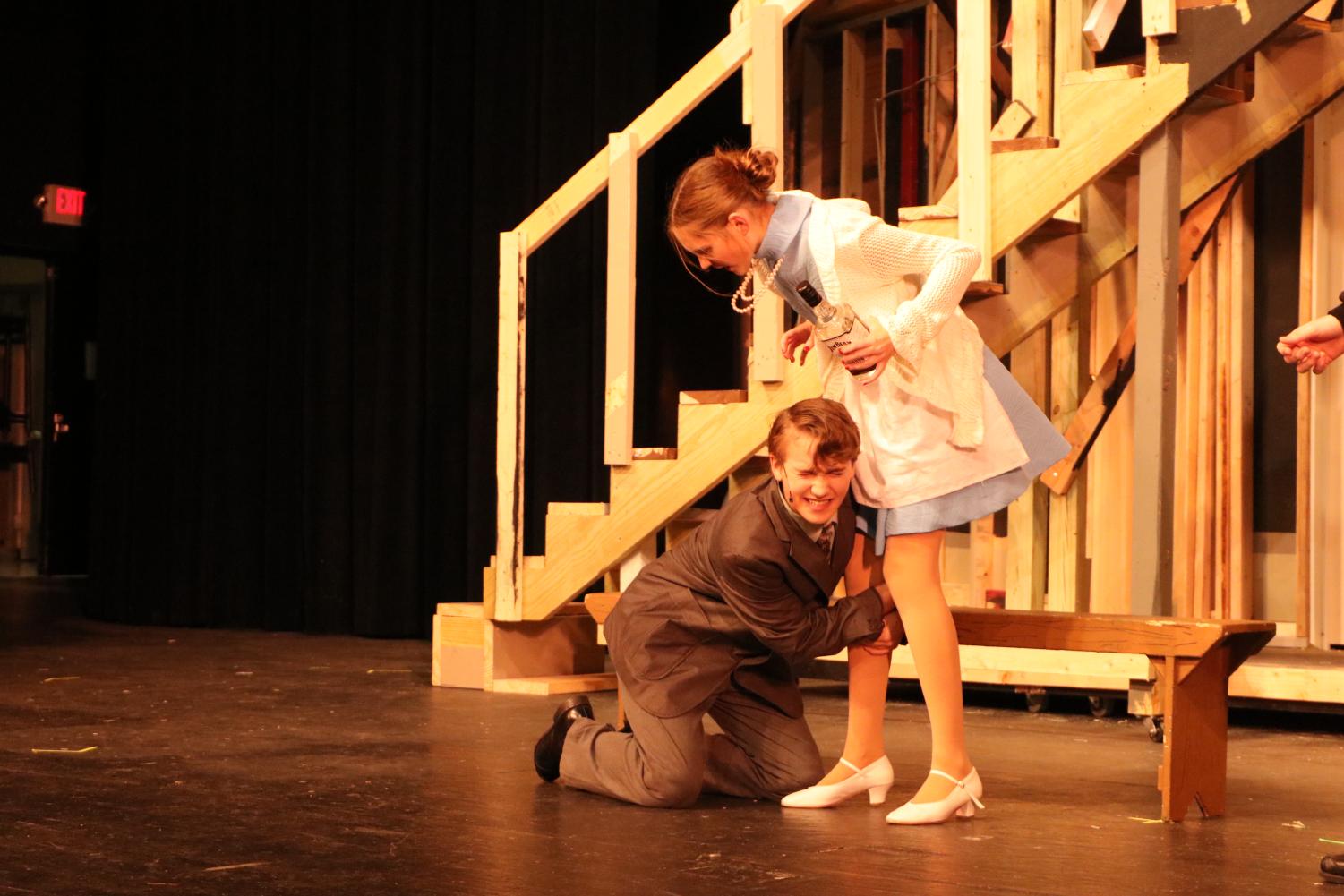 While begging Dotty Otley (freshman Mary Donavan) to take him
back, Garry Lejeune (freshman Jackson Schertzer) grabs on to her leg. The Falcon Players performed their fall play Noises Off from Dec. 1-3.