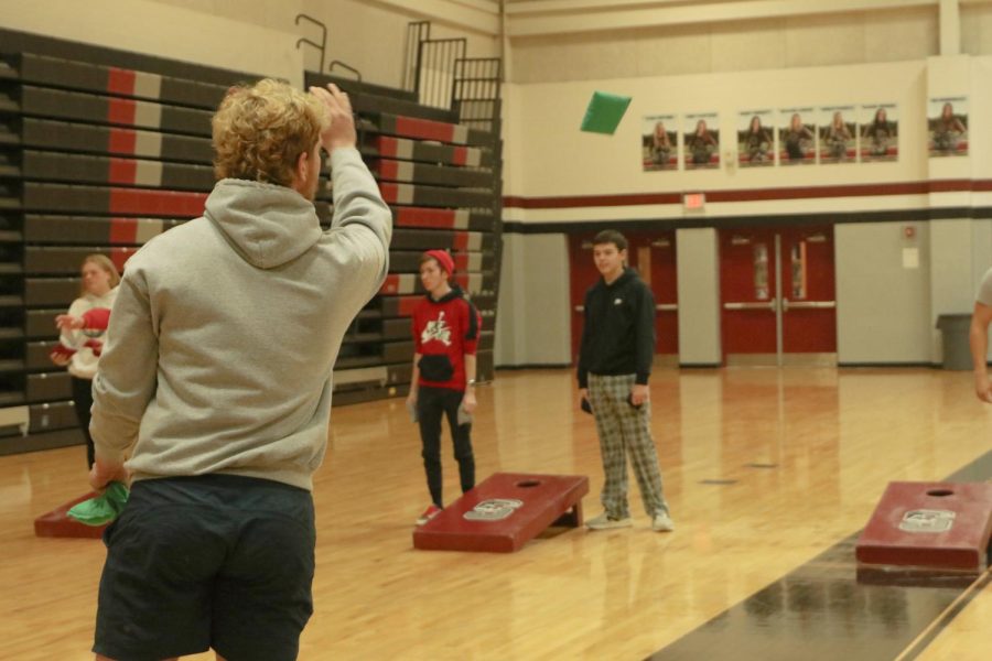 During the AcLab bags tournament, junior Grant Gibson launches his bag. The P.E. department hosts AcLab tournaments for a different sport every month.