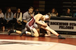 Senior Buckley Rohan initiates a take down against Justin Venable of Oakville, giving Rohan the lead on the match. Rohan won his match 8-0. The Falcons fell to the Oakville Tigers 45-33 on Dec. 7.