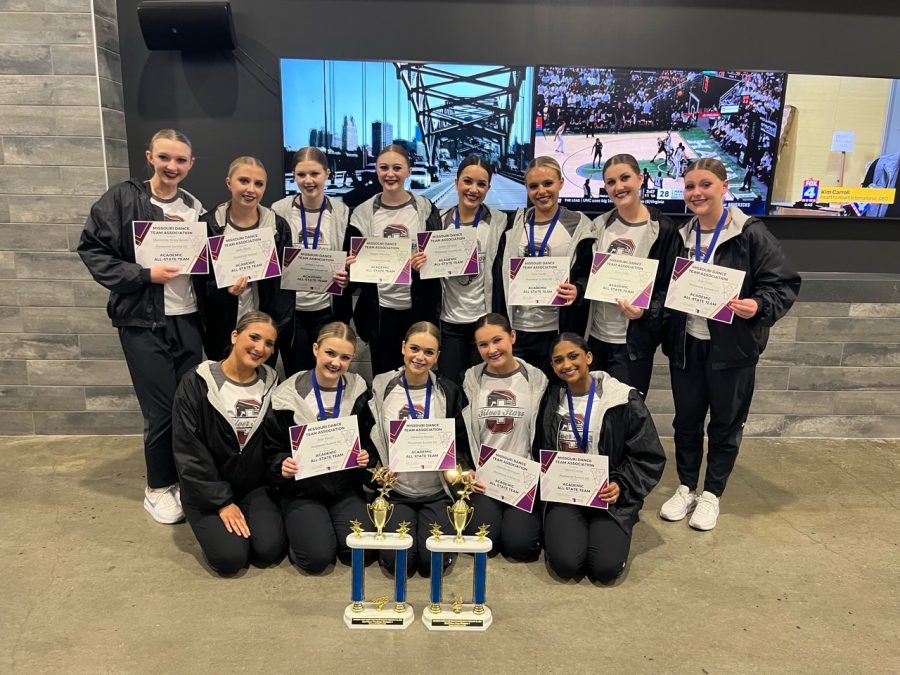 After+performing+at+the+2023+State+competition%2C+the+varsity+Silver+Stars+dance+team+crowds+around+their+trophies+and+hold+up+their+All-State+academic+honor+certificates.+The+dance+team+took+2nd+in+pom+and+2nd+in+%28Photo+used+with+permission+by+Erin+Taylor%29