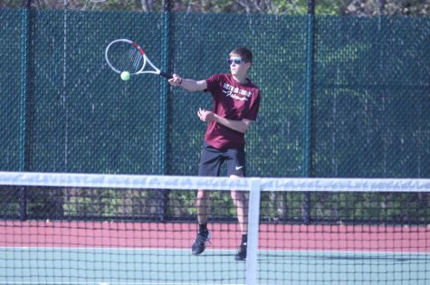 As he swings his racket, freshman Max Otto returns the ball. The Falcons were swept by the Webster Groves Statesmen, losing 9-0.