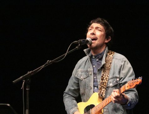 As he plays the guitar, Javier Mendoza sings for the crowd. Mendoza performed a concert for Spanish students in the theater on April 14.