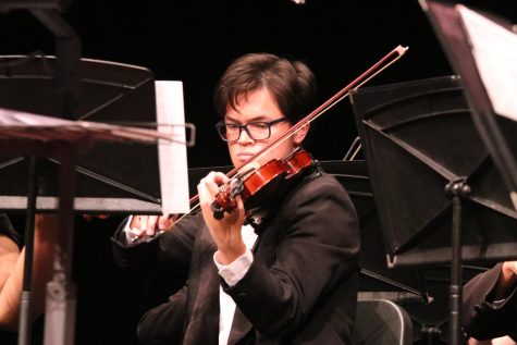 As one of the second violins, junior Alex Nguyen plays with the symphonic orchestra during their spring concert. The concert took place on May 9.