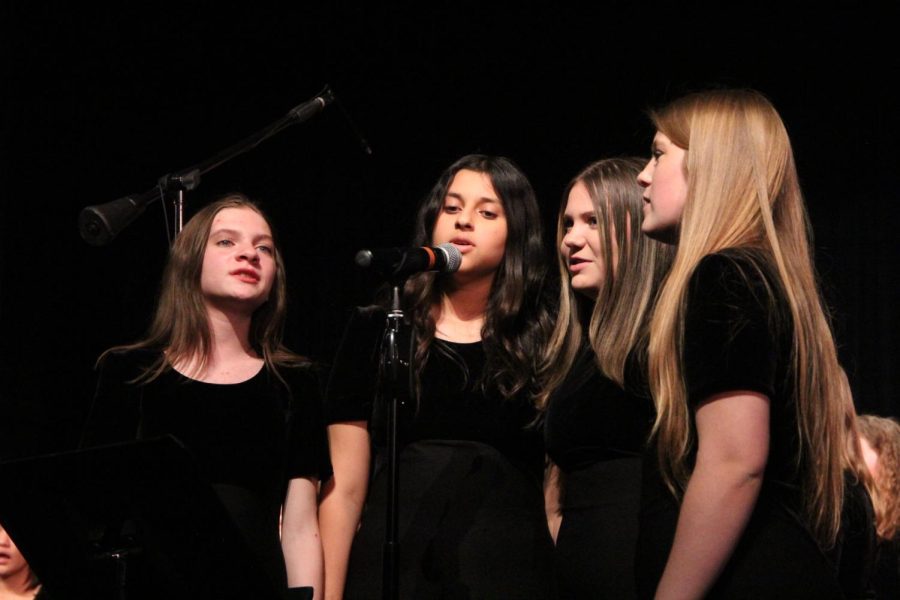As members of the treble choir, (from left to right) freshmen Lauren Laffleur, Lamar Alrubayie, Ella Gettemeier, and Lillian Lane perform as a quartet. at their fall concert. The concert was held on Oct. 16.