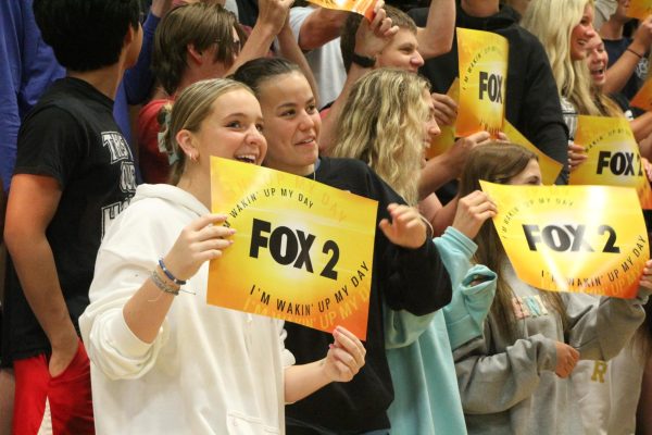 From the student section, seniors Ellie Kappler hold up Fox 2 News as the camera pans around the gym. The pep rally took place on Sep. 1 before the football game against Marquette that night.