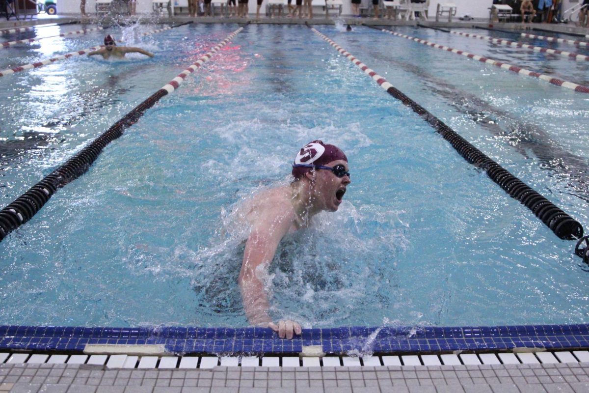 Senior George Swayne completes an open turn during the tri-meet against Washington and Westminster on Sept. 1. Swayne finished1st in the 100 fly with a time of 1:07:10. 