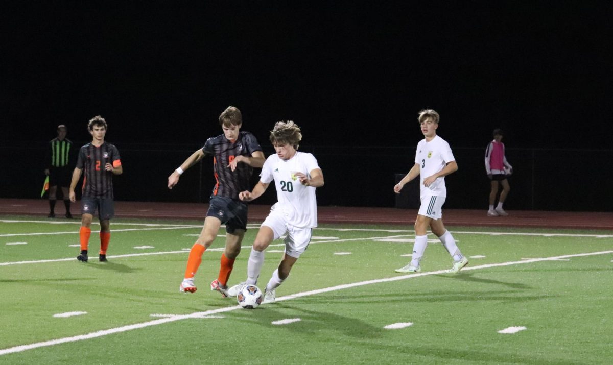 In attempt to steal the ball, senior Ian Boden (8) runs by Mike Waller
(20) of Lindbergh. The Falcons defeated the Lindbergh Flyers with a
score of 2-1 on Oct. 20th. “My mindset for the game was to prove to
everyone who we are,” Boden said.