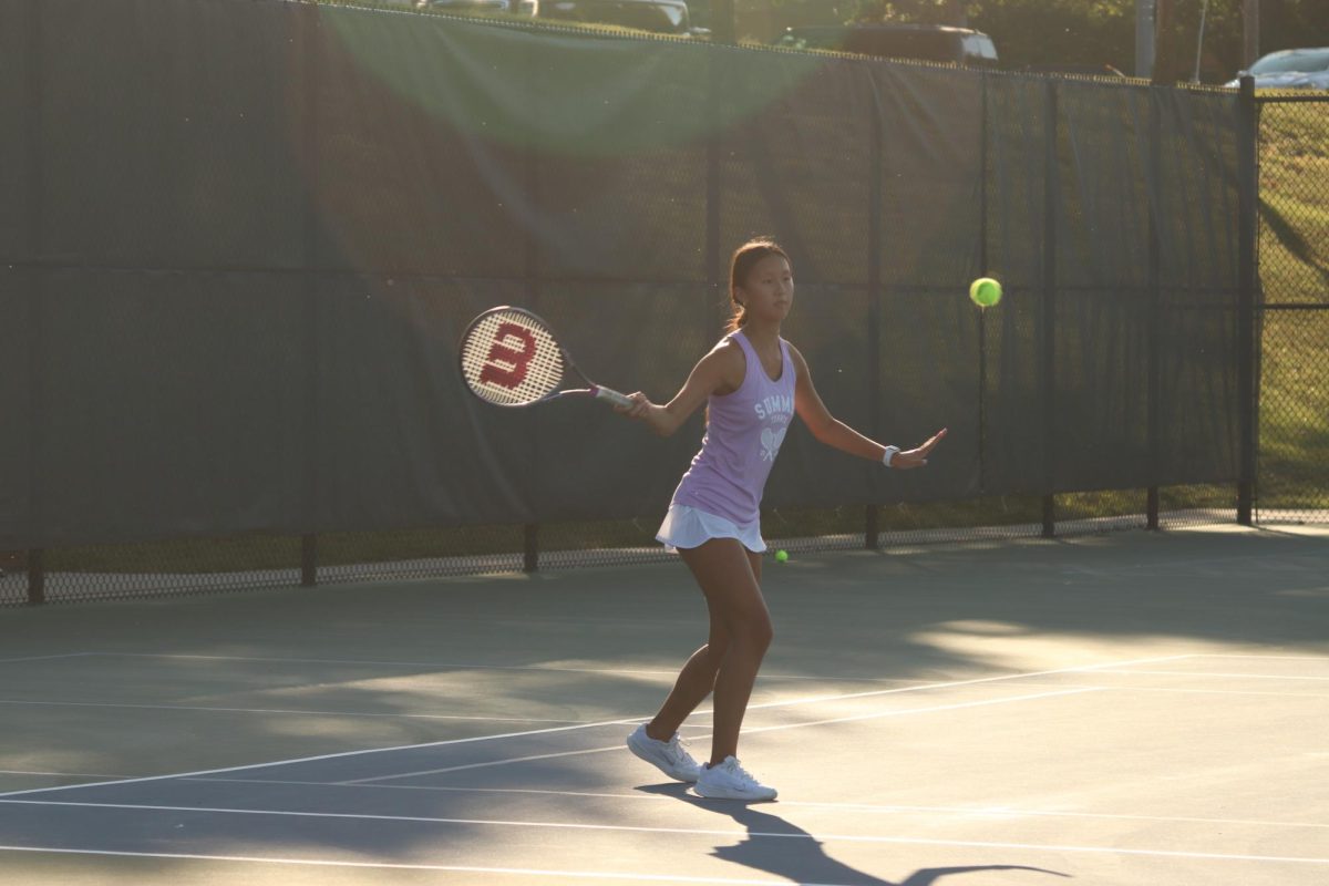As+the+ball+comes+barreling+towards+her%2C+sophomore+Isabel+Duan+prepares+to+strike+it+onto+the+Nerinx+side.+Junior+Ava+Thines+and+Duan+lost+their+district+doubles+match+8-0+on+Oct.+2.