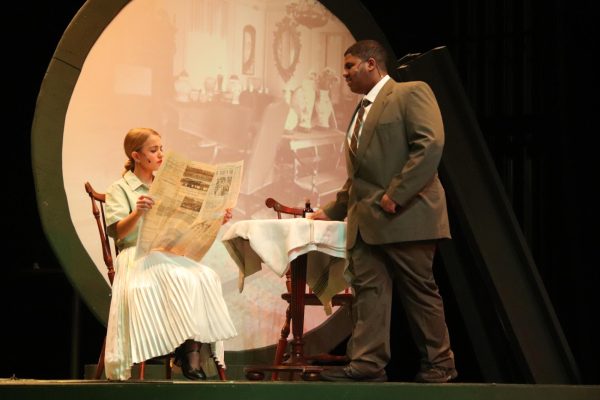 Returning home, Arthur Roeder (junior Ridwan Osman) finds his
wife Dianne (junior Aliza Carlson) reading a story in the newspaper
about the radium girls’ case against the corporation, calling out the
company for lying to the girls and the Department of Labor.