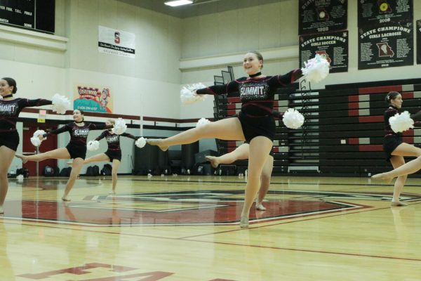 During their pom routine, junior Allie Cross completes a turn. Before the Lindbergh Invitational on Dec. 2, the team debuted their performances for friends and family on Dec. 1. 