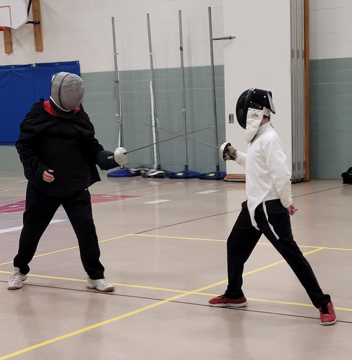 At his first fencing class, freshman Dominic Darby fences his instructor. “My instructor was teaching the basics of things like parying and movement,” Darby said.
