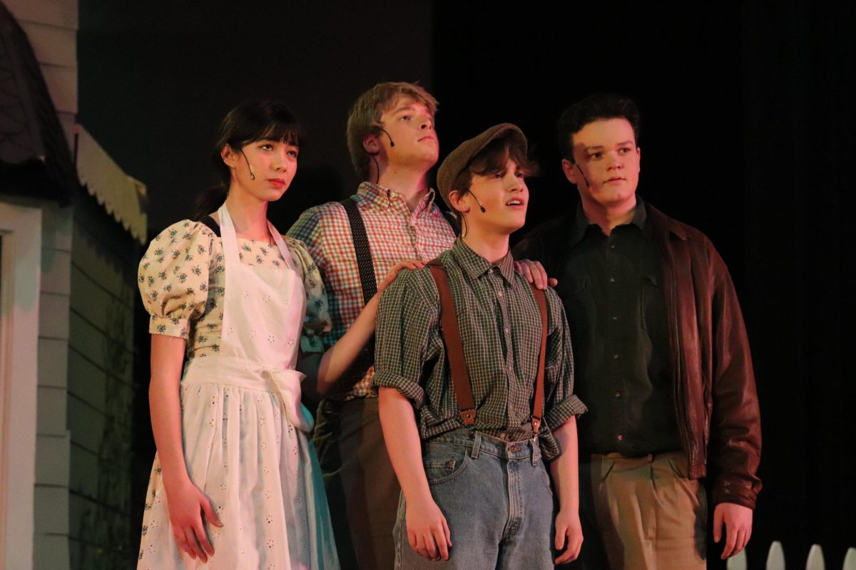 As the Tuck family reflects on their journey, Mae (junior Shekinah Annin), Angus (senior Zach Hardee), Jesse (sophomore Jackson Schertzer) and Miles (junior Michael Stimpson) sing the The Wheel (Finale) during Tuck Everlasting. The musical took place on Mar. 7-9, though preparations began in December. 