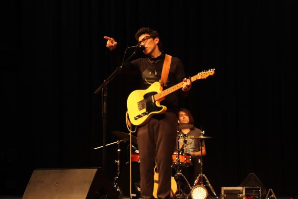 In the theater, Javier Mendoza points to the crowd of students attending his concert. The concert took place on April 5.
