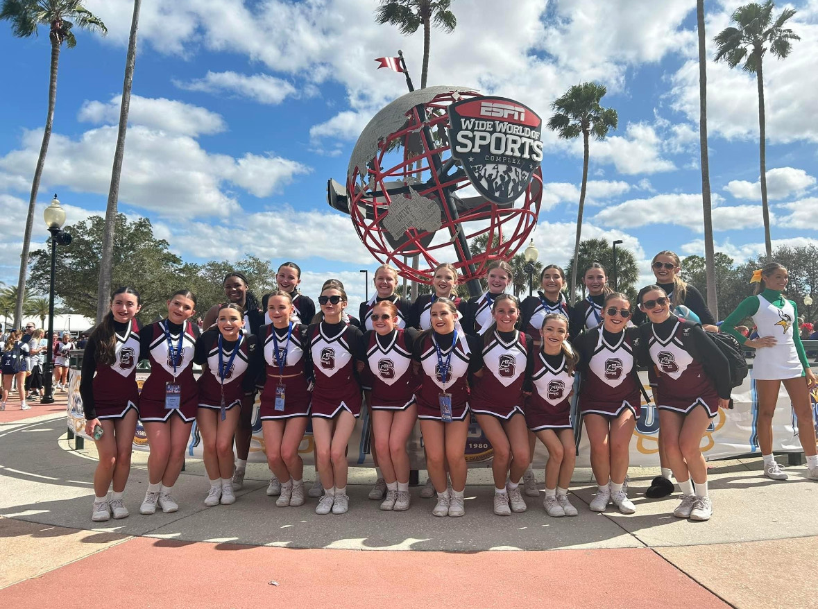 Before+their+competition%2C+the+cheerleading+team+pose+near+the+ESPN+Wide+World+of+Sports+Complex.+The+Falcons+competed+at+their+first-ever+National+competition+on+Feb.+10.
