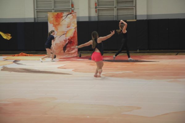 While running through the winter guard routine, freshman Georgia Teller dances to “California” by Chappell Roan at practice on March 14. The guard won first place at their competition at Edwardsville High School on March 2. 