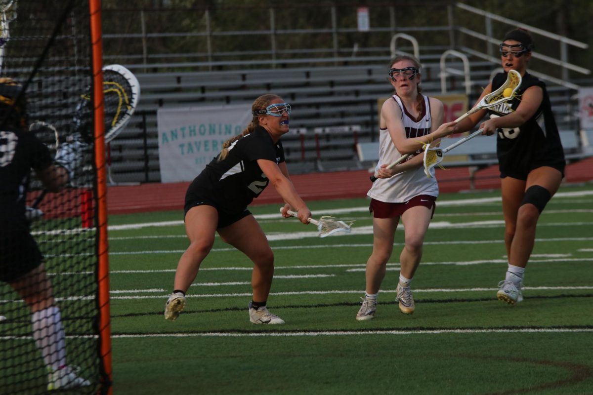 With 25 seconds left in the quarter, junior Addyson Horn scores on Lafayette as senior Talia Manor 25 of Lafayette and sophomore Hayden Miller 28 of Lafayette try to stop the goal. The girls lacrosse game took place on April 15. 