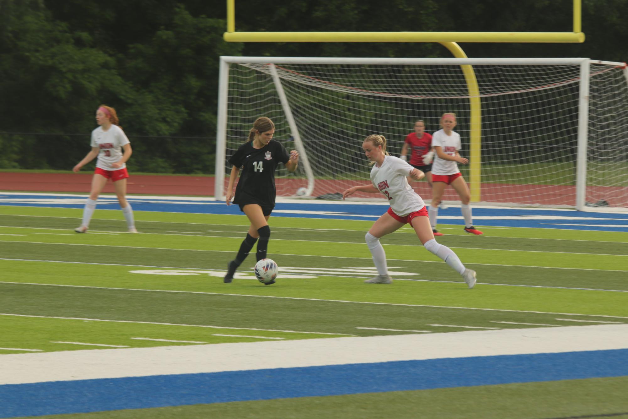 Senior Abby Larocque dribbles the ball towards the goal while avoiding the opposing team.
