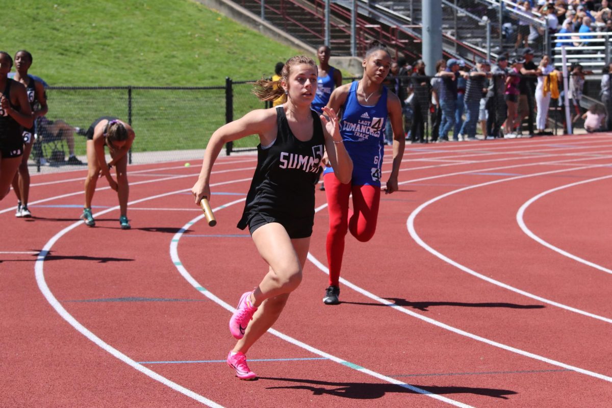 With a baton in hand, senior Ali Sandler strides forward ahead of Kendra Jennings of Cahokia. The 4x100m relay placed fourth at the Siebert Finch Invitational on April 13. 