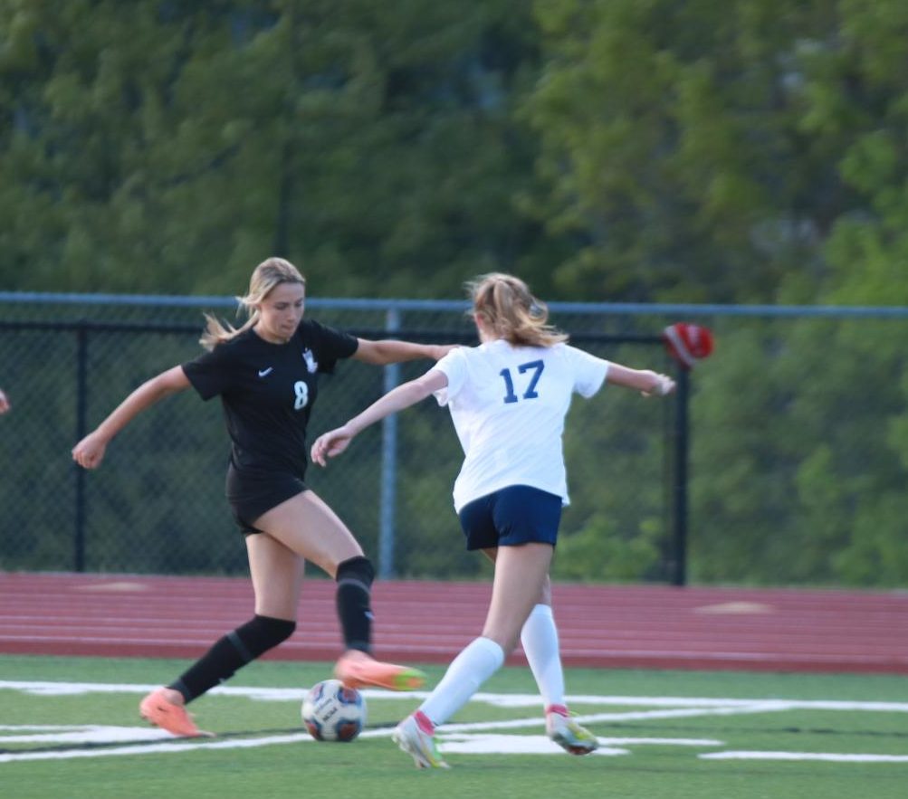 Freshman Maddeson Chonech attempts to divert the ball from Lauren Shuert (17) of Marquette. The girls lost to Marquette 2-0 on April 22 and went on to defeat Fort Zumwalt
South.