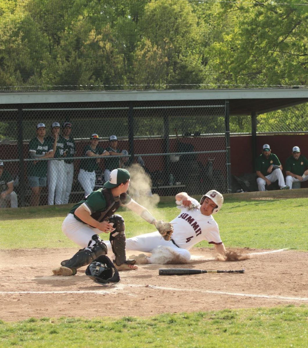 While running to home base, junior Gabe Sieve is forced to slide in order to avoid being tagged by the catcher. After controversy over the play,
the umpire made the call that Sieve was out.