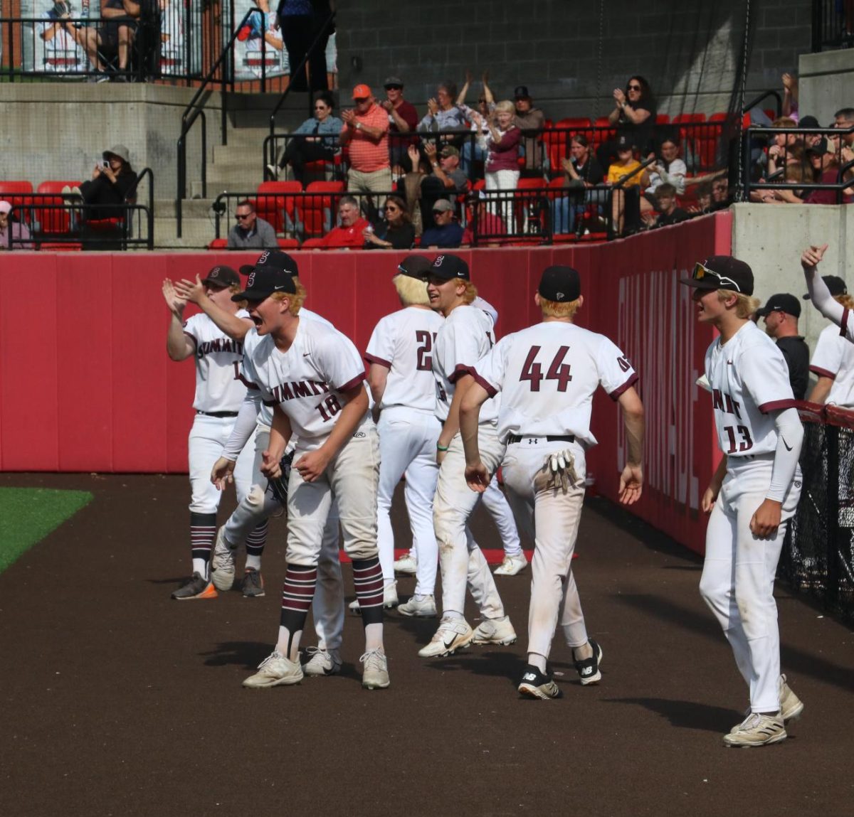 Coming out from the dugout, senior Logan Darnell, juniors Cameron Mosier and Blake Bell, sophomore Micky Plemmons, junior Austin Althoff, and sophomore Carter Nagel celebrate a home run. 