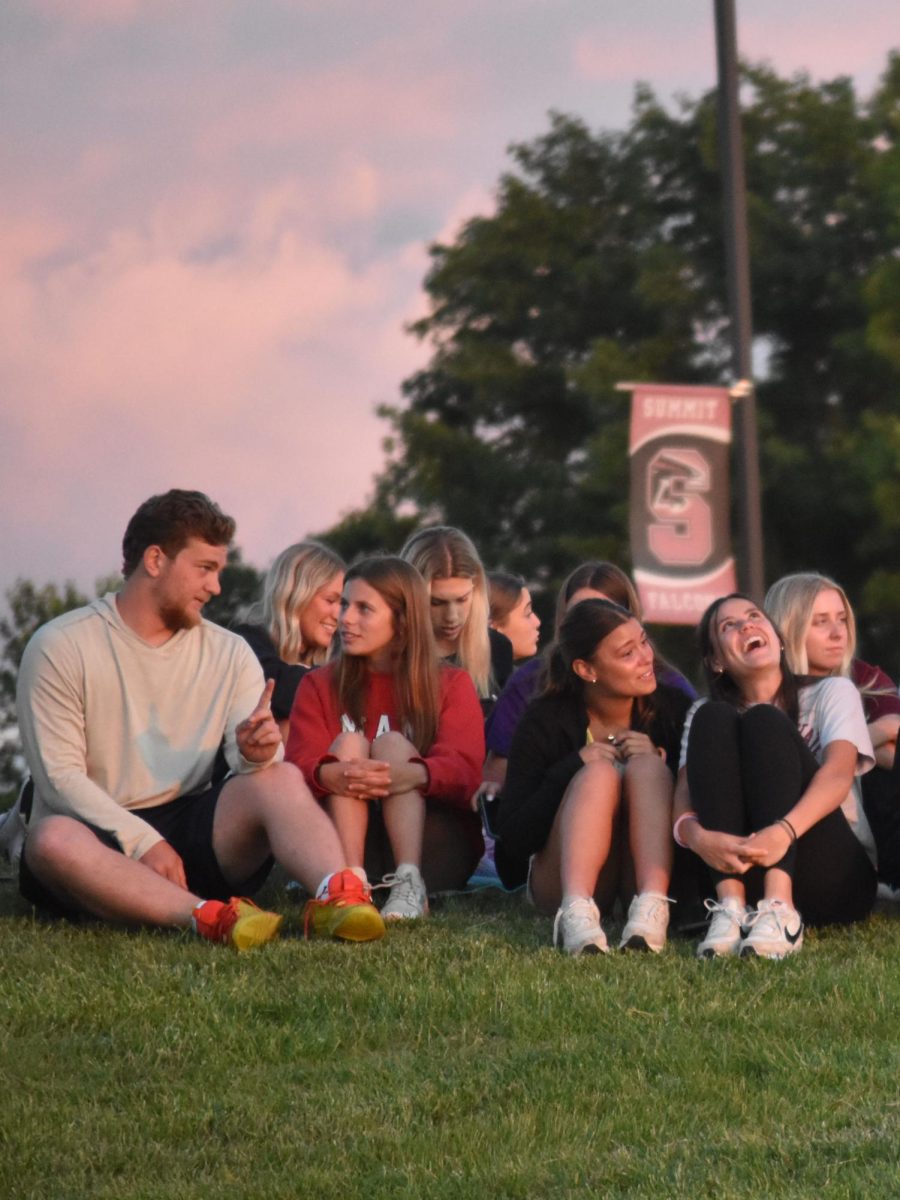 Seniors Grant Gibson, Ali Sandler, Ellie Morris, and Mia Brown talk with each other as they watch the sunset over their last day as high schoolers. 