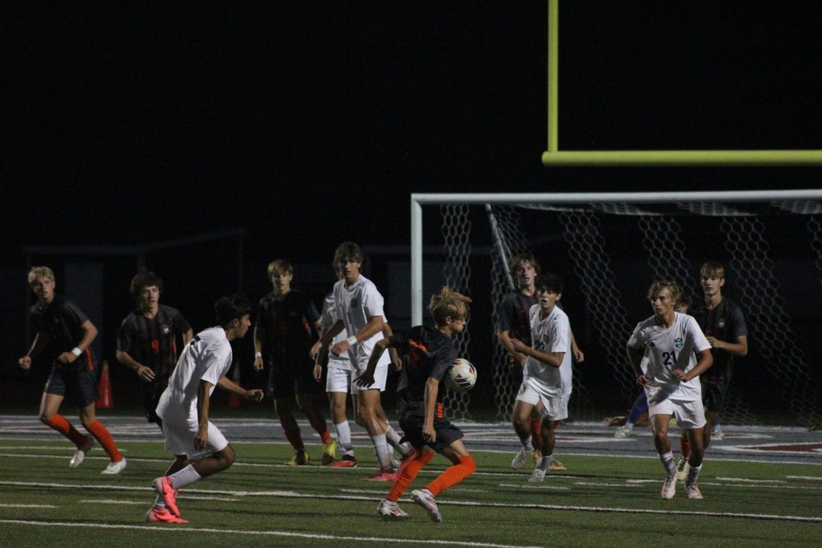 Freshman Quince Larocque (16) chests the ball during the second half.