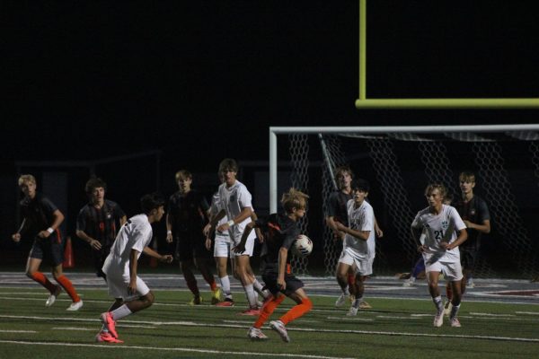 Freshman Quince Larocque (16) chests the ball during the second half.