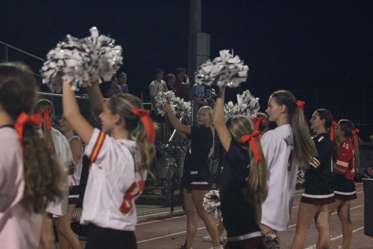 Summit's varsity cheer team support varsity soccer on September 11th.