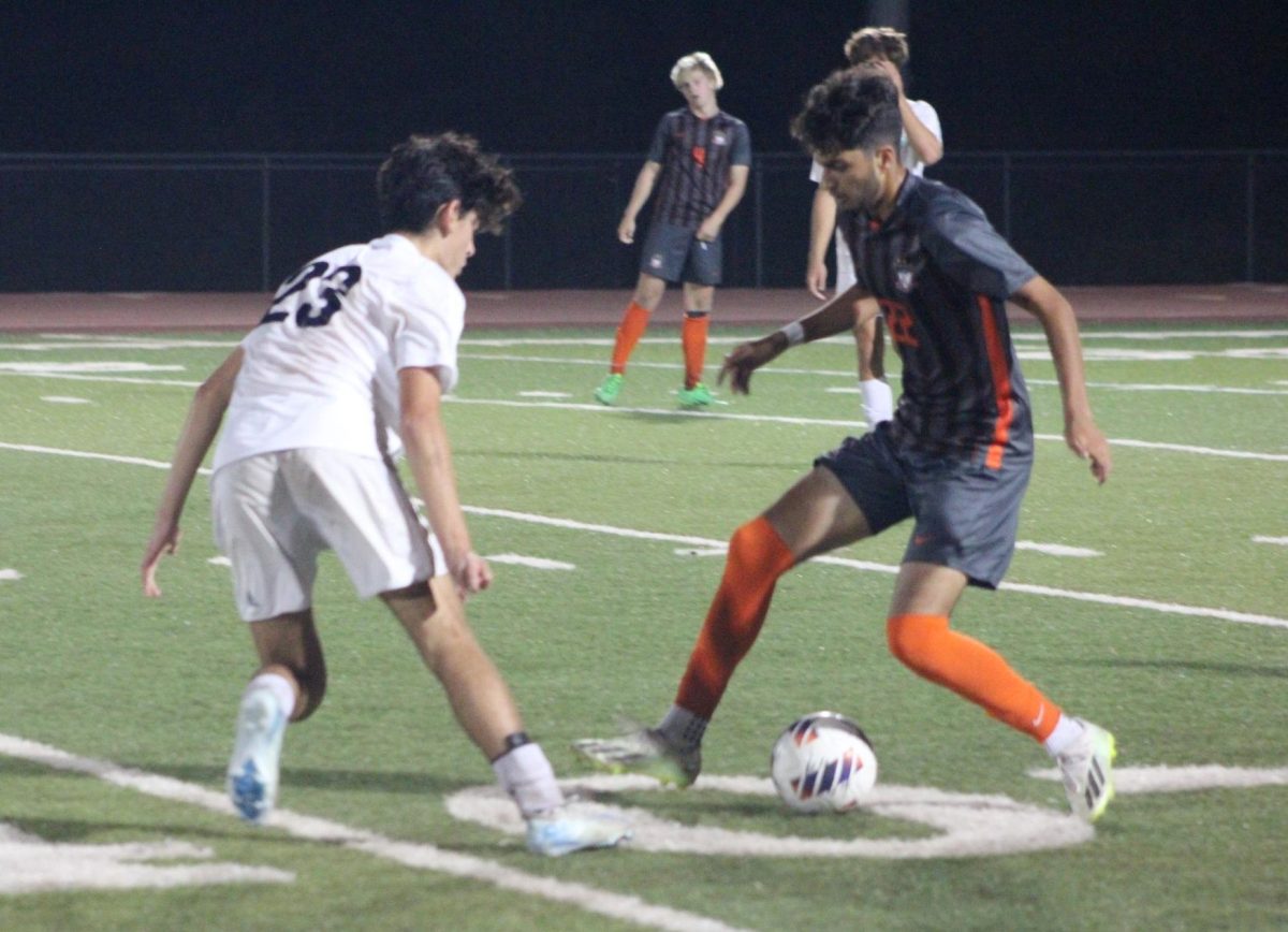 Junior Hamza Ahmad (22) does a step-over while attempting to get past Marquette defender Teo Airasca (23). Summit overcame Marquette in the second half to win 2-0 on Sept. 11. 
