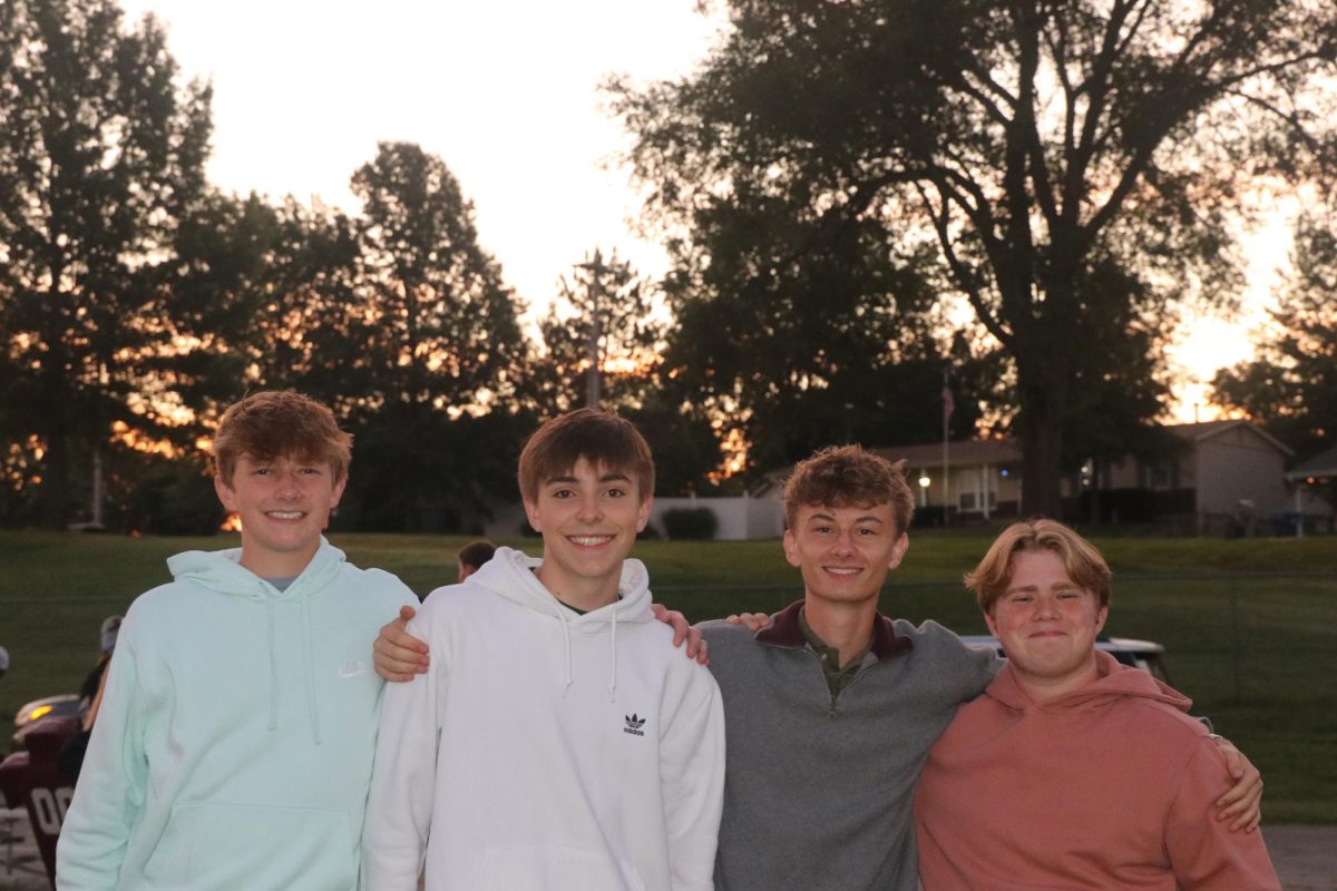 Seniors Carter Field, Andrew Mehler, Avery Madurah, and Jonah Roberts smile as they wait for the sun to come up. “While it was a little underwhelming, I still had a great time hanging out with and talking to my friends,” Roberts said. 
