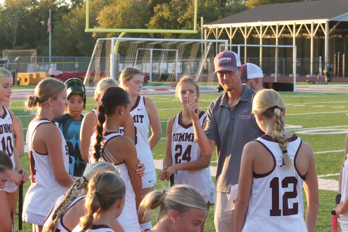 Coach Andrew Neil gives a talk to his team between periods.