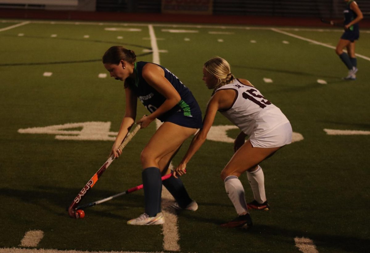 Senior Sienna Nicholson (15) jockeys for the ball with Mady Huff (10) of Marquette. The Falcons lost to Marquette 1-3 on Sept. 25.