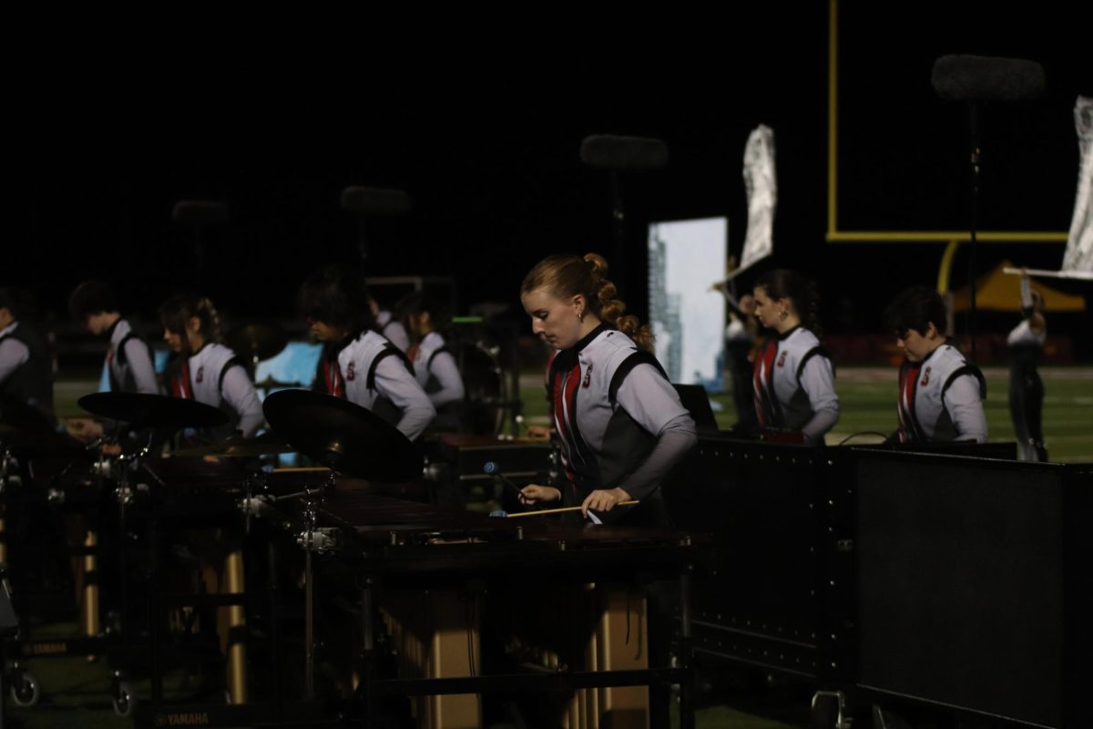 At Ryan Hummert Night for the first home football game on Sep. 13, sophomore Claire Bailey plays the Marimba during the Silver Falcon Marching Band's halfitme performance. This year, the show is named 'Beyond the Sidewalk,' and features the different emotions of growing up.