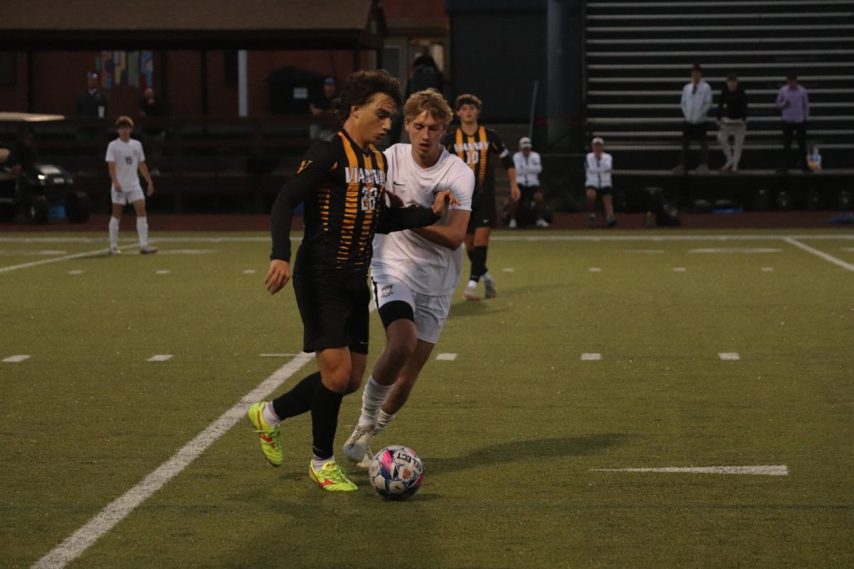 As Vianney player Leo Mermelstein (28) pushes senior Joe Schicker, Schicker keeps his stance in an effort to get the ball back.