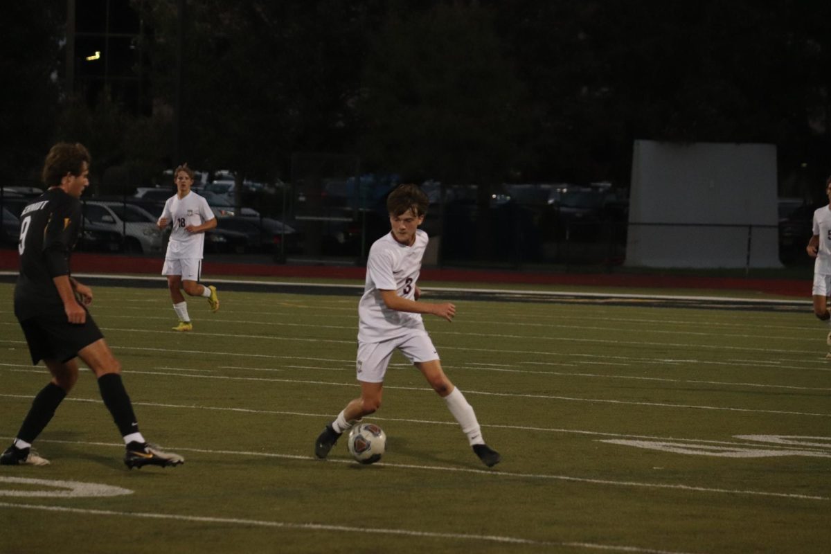 Senior Teddy Williams attempts to keep possession of the ball as he pulls away from Vianney player Nathan Schmidt (9).