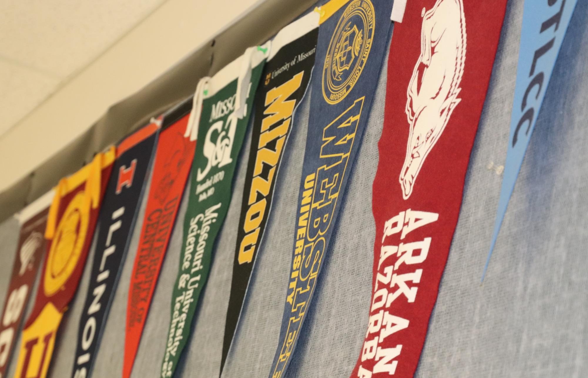 Banners hang in front of the counseling office representing Falcon's college choices.