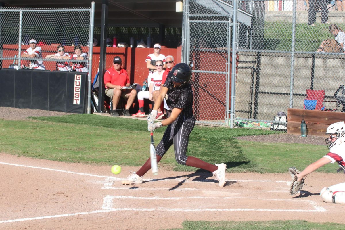 As the pitch comes flying towards her, sophomore Emily Perone swings towards the ball. The Falcons beat Cor Jesu 11-5 on Oct. 2.