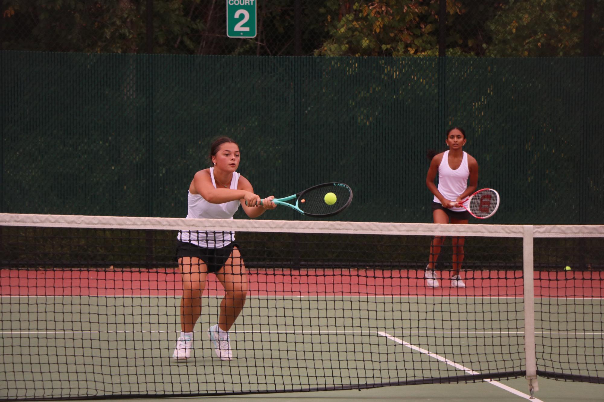 Junior Aditi Vangala stands in ready position as sophomore Ayda Demerit volleys a ball against Pattonville. The varsity team lost to Pattonville 1-8 on Sept. 12.