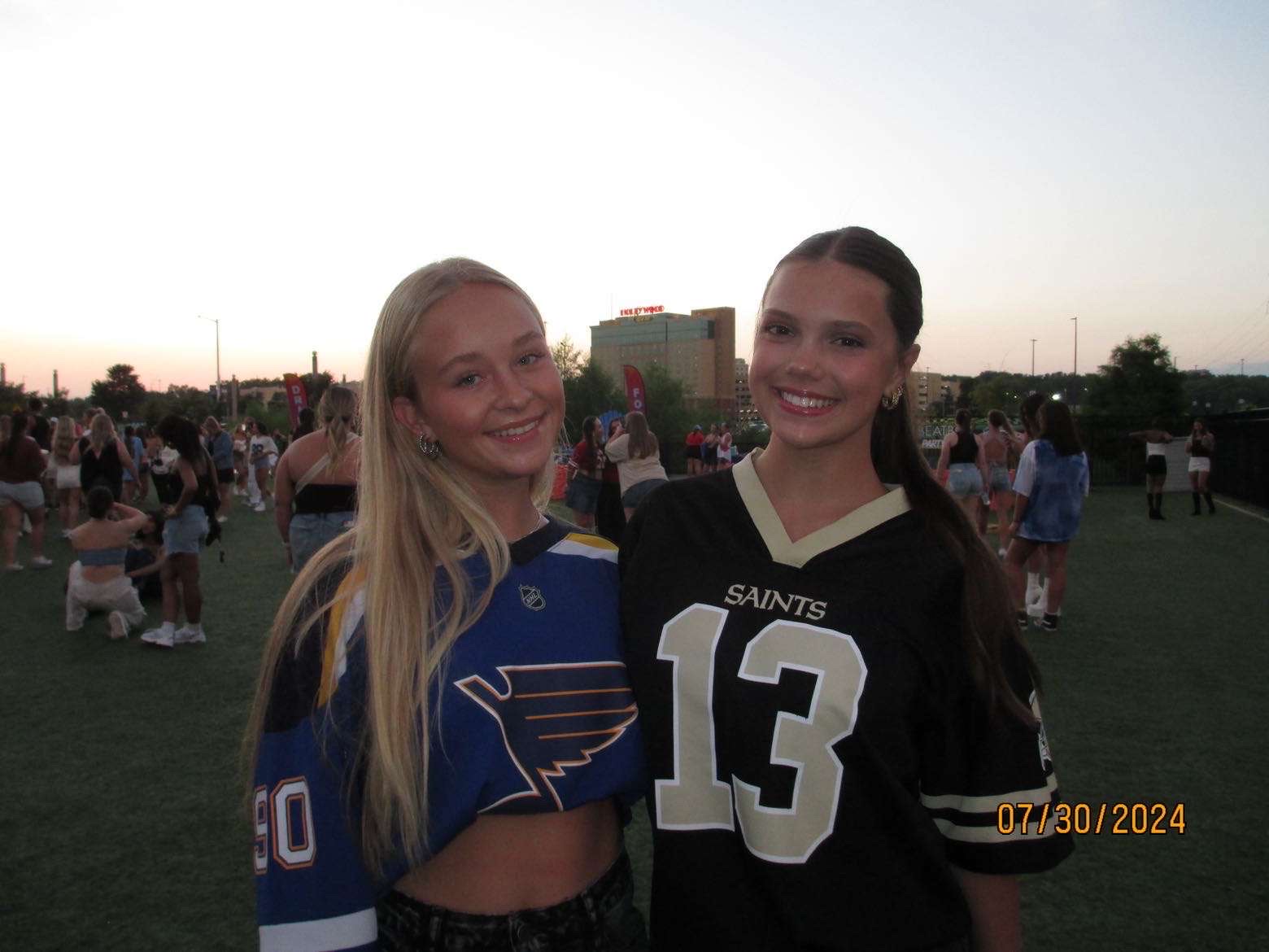 Juniors Emory Reinen and Aubrey Roper pose in the grass of St.Louis Music Park before Tate Mcrae makes the stage. 